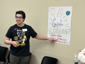 WIScholar Diego Miranda-Gandarilla points to "Problem-Solving" on a group poster as one of the benefits of language learning.