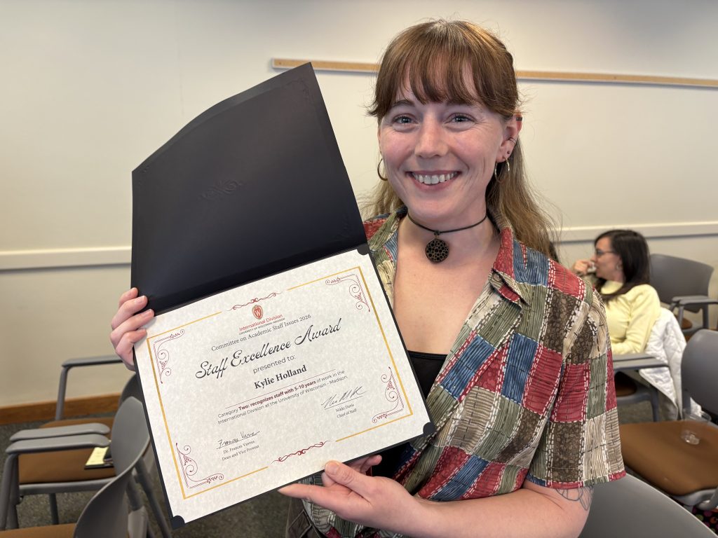 Photo of Kylie Holland holding her award