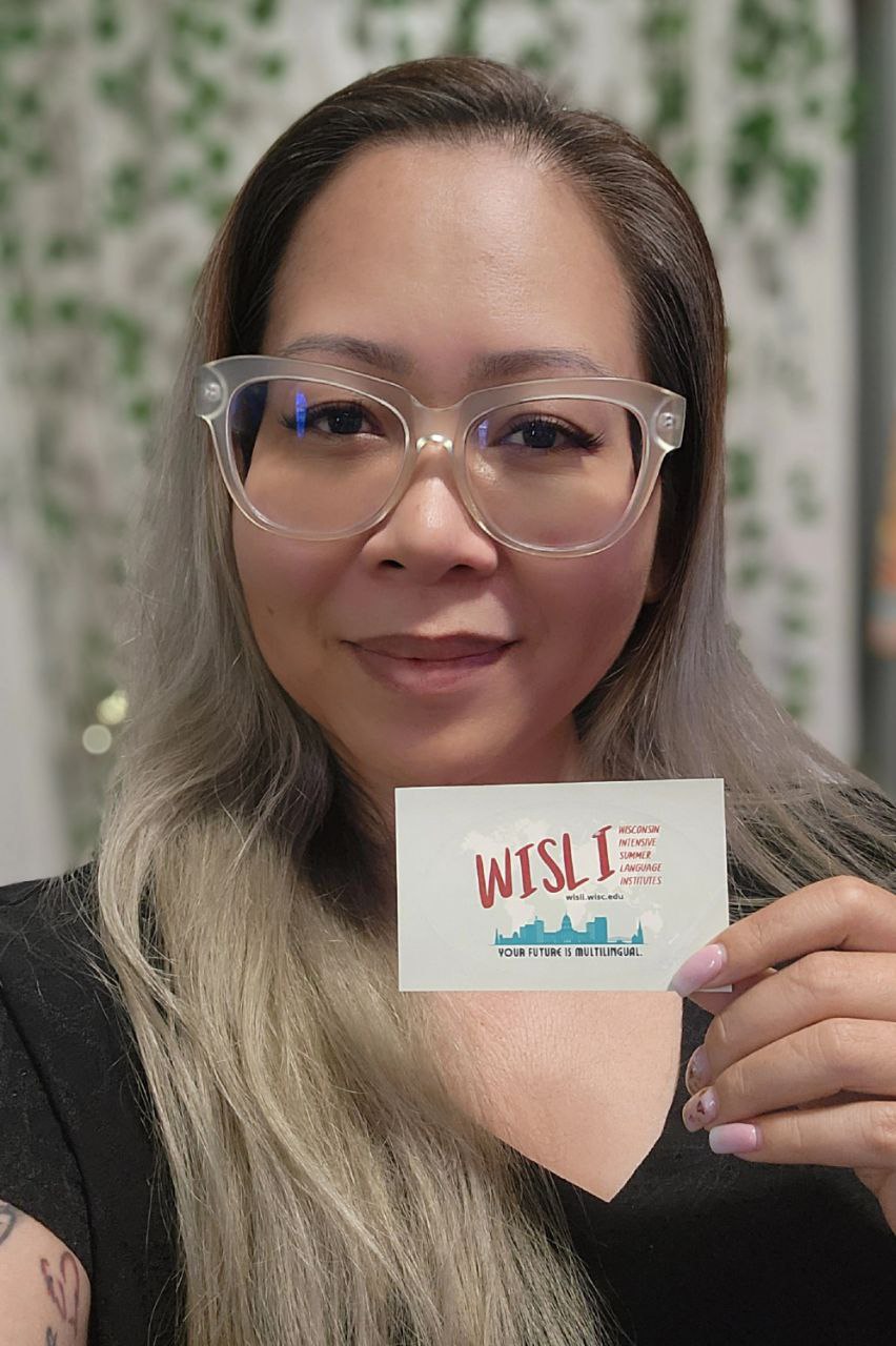 Sophea holding a WISLI sticker.